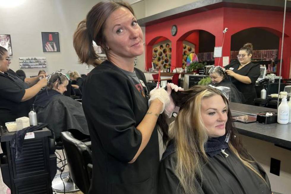 a person cutting the hair of a person