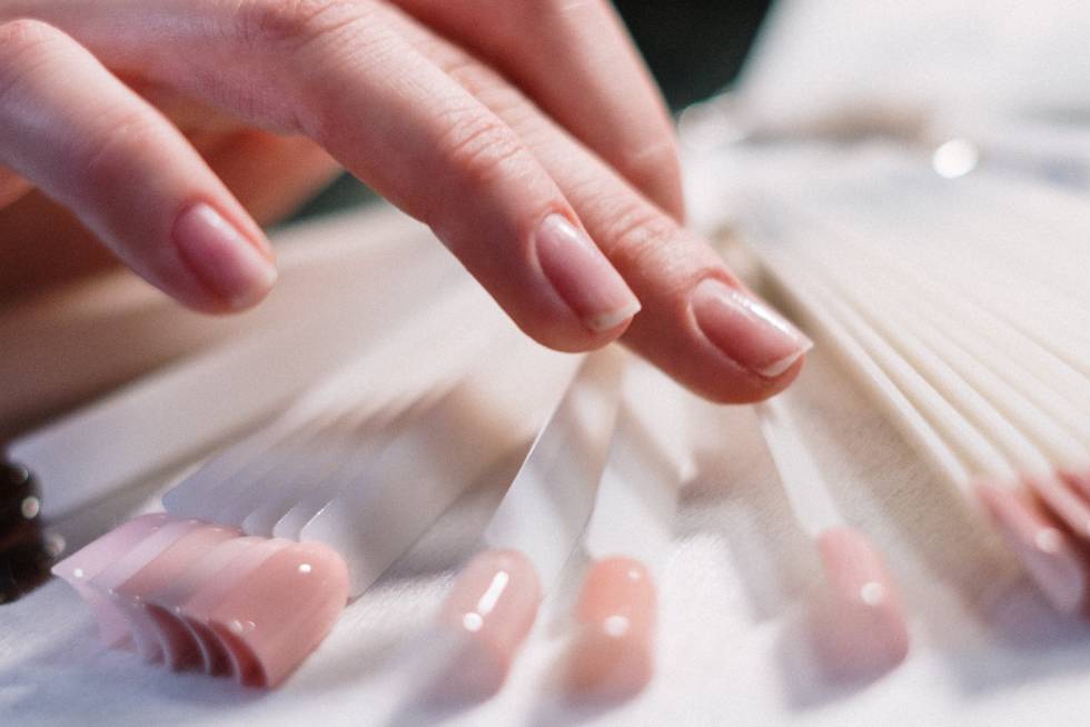 a close-up of a hand touching a nail file