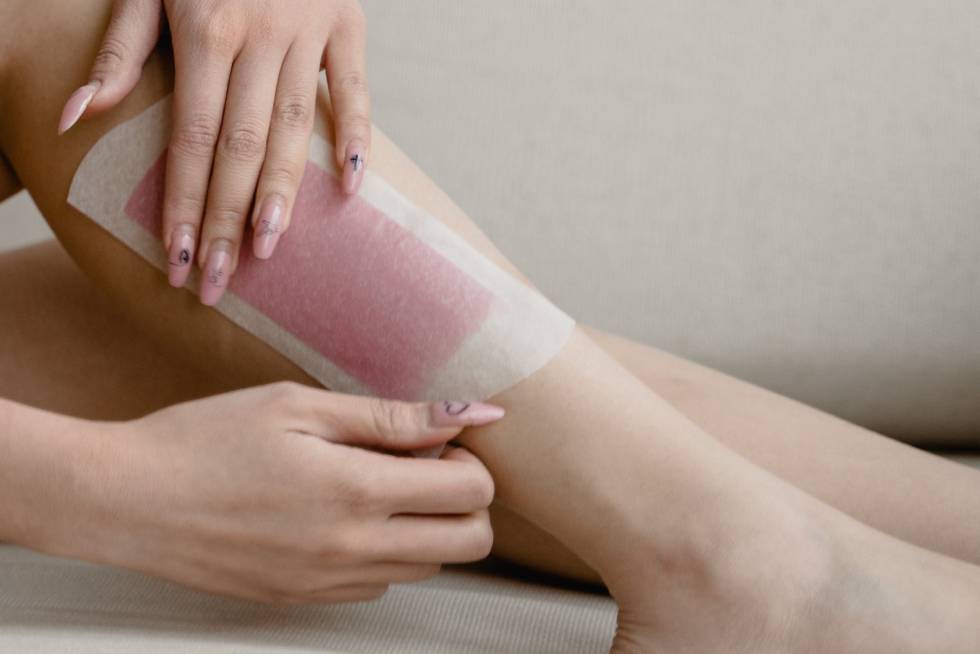 a woman waxing a leg